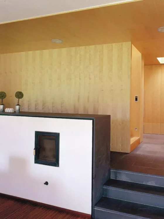 Moderner Wohnraum mit maßgefertigten Holzvertäfelungen, integriertem Kamin, Treppe und minimalistischer, Referenz