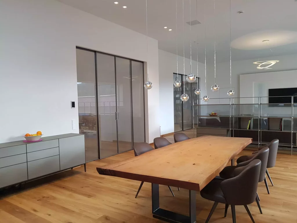 Moderner Essbereich in Villa Stuttgart mit massiver Holztischplatte, Lederstühlen, Rimadesio Glastüren, Referenz